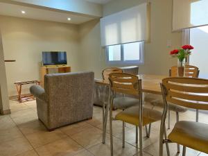 a dining room with a table and chairs at Inter Apart Hotel in Salta