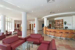 a lobby with couches and a bar in a building at Hotel Fenix in Sunny Beach