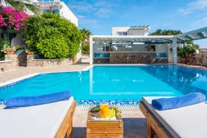 a villa with a swimming pool and a house at Orizontes Boutique Studios in Adamantas