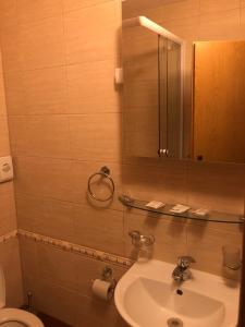 a bathroom with a sink and a toilet and a mirror at Slanický Dvor in Námestovo +59 photos