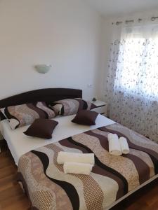 Postel nebo postele na pokoji v ubytování Apartmani Ivan