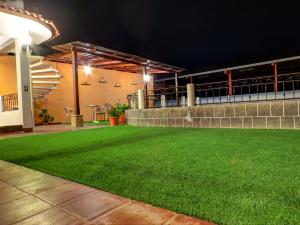 a lawn in the middle of a building at night at SHANTI SHANTI Hotel & Restaurante in San Pedro La Laguna