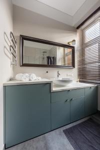 a bathroom with a sink and a mirror at Laisves ave. Apartments in Kaunas
