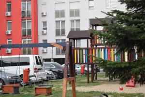 a playground in a park in front of a building at Sweet Residence Apartment in Arad