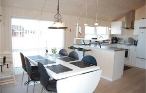 a kitchen with a table and chairs in a room at Amazing Home In Tarm With Sauna in Tarm