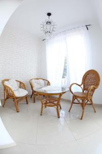 a dining room with a table and chairs and a chandelier at Bryza in Łeba