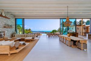 an open living room with a stone wall at Asi Chaweng 6 BR sea view in Koh Samui 
