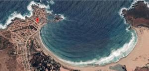 an aerial view of a beach with the ocean at Cabañas Armandiños in Pichidangui