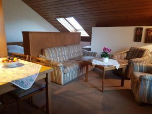 a living room with a couch and a table at Haus Talblick in Stocksberg
