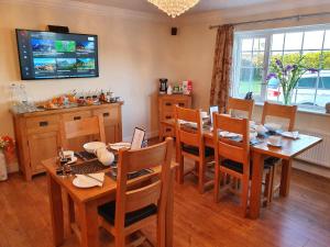 a dining room with a table and chairs at Craig Eithin B & B in Holyhead