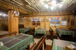 a restaurant with tables and chairs in a room at Nebokrai in Yaremche