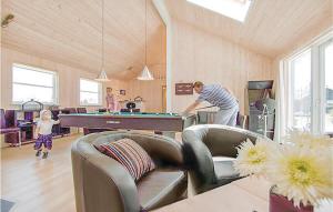 a man playing a game of pool in a living room at Nice Home In Idestrup With Sauna in Marielyst