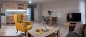 a living room with a couch and a table at City Apartments in Liptovský Mikuláš