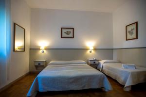Postel nebo postele na pokoji v ubytování Hotel Ai Tufi
