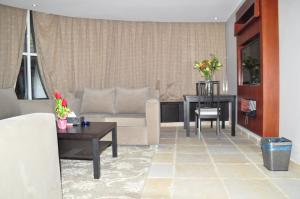sala de estar con sofá y mesa en Tooq Suites, en Riad