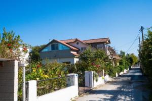 a house on a street with a white fence at Kassiani House in Ioannina