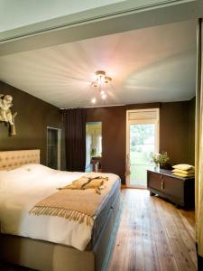 sypialnia z dużym łóżkiem i oknem w obiekcie De Zevende Hemel w mieście Merendree