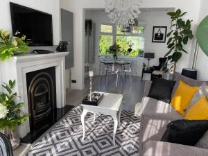 a living room with a couch and a fireplace at Luxury 5* Home with Secret Garden and Free Parking in Liverpool