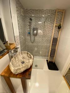 a bathroom with a sink and a shower at Luxury 5* Home with Secret Garden and Free Parking in Liverpool