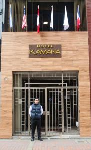 a man standing in front of a building with a sign at Kamana Hotel in Lima