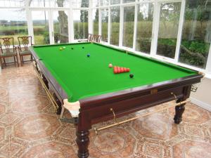 a pool table with balls on it in a room at Ashleigh House - HOT TUB, Snooker table, Sleeps 24 in Henley in Arden