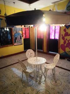 une table et quatre chaises dans une pièce dans l'établissement Hostal Oaxaca Magic, à Oaxaca