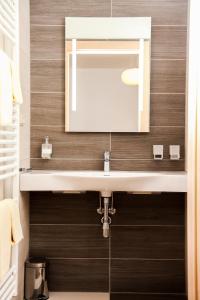 a bathroom with a sink and a mirror at Weingut Zirngast in Leutschach