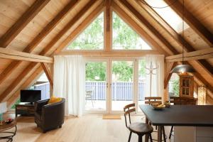 a living room with a large window and a table at Sophies Scheune, nah beim Europapark in Ettenheim