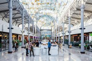 a large shopping mall with people standing in it at La suite musicale in Villeneuve-Saint-Denis