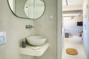a bathroom with a bowl sink and a mirror at SifnosLiving A3 in Vathi