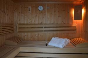 a room with a sauna with a clock on the wall at Ferienhaus Eifel-Charme in Birgel
