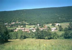 a village in the middle of a field with trees at Ferme des baillards in Bélesta