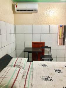 a room with a bed and a table and a table at Hotel Fortaleza III Manaus in Manaus