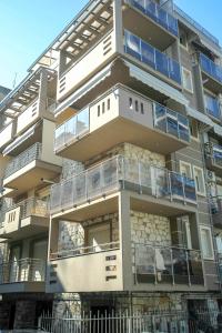 an apartment building with balconies on the side of it at Zen & Geo's HOME in Thessaloniki