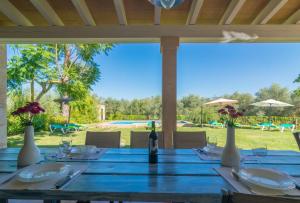 a wooden table with a bottle of wine on it at Mercader in Alcudia