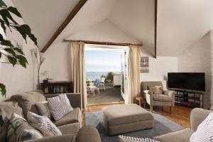 a living room with a view of the ocean at Little Trevara, Marazion in Marazion