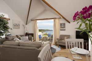 a living room with a couch and a table at Little Trevara, Marazion in Marazion