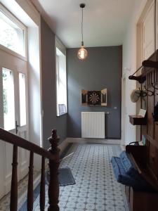 a hallway with a staircase with a stair at La Maison du Maître in Dinant