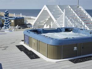 a hot tub on the deck of a house at Boardwalk Plaza Hotel in Rehoboth Beach