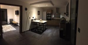 a kitchen with a table in the middle of a room at Gite Le Petit Malsbach Eguisheim in Eguisheim