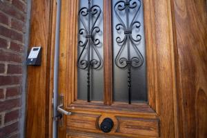 an open wooden door with a metal railing at La Dimiere - Le Postel - Appartements de standing en hyper-centre - Louviers in Louviers