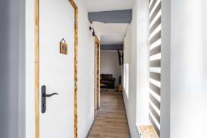 a hallway with a door and stairs in a house at La Dimiere - Le Postel - Appartements de standing en hyper-centre - Louviers in Louviers