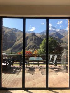 a view of a table and chairs from a window at Hilltop Kazbegi in Stepantsminda