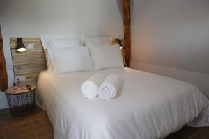 a bed with two rolls of towels on it at Villa Noellet - Clermont Ferrand in Aubière