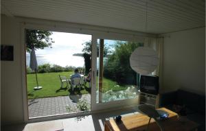 a living room with a sliding glass door to a patio at Mindegården in Hejls
