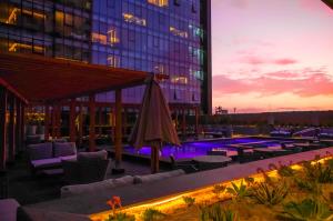 a hotel patio with a pool and a building at QUARTZ HOTEL & SPA in Tijuana