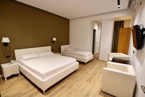 Postel nebo postele na pokoji v ubytování Aurelis Hotel
