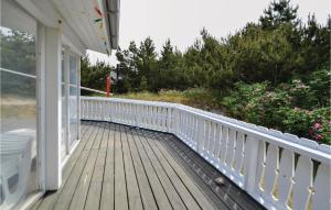 a porch with a white railing on a house at Holiday Home Hvide Sande 48 in Bjerregård
