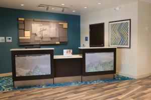 a room with two large flat screen televisions at Holiday Inn Express & Suites - Hendersonville SE - Flat Rock by IHG in Flat Rock
