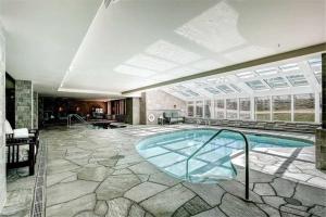 a large swimming pool in a building with a large window at One Ski Hill Place 8307 - Ski-In Ski-Out Apartment in Breckenridge